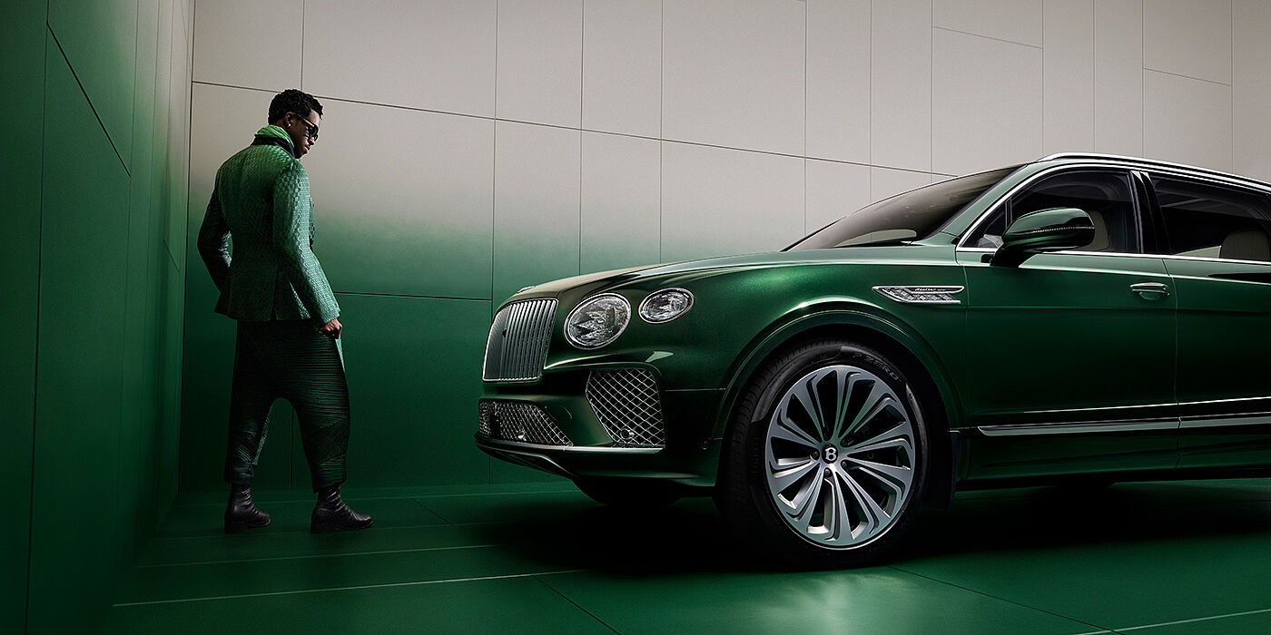 Bentley Düsseldorf Wisdom K standing next to Bentley Bentayga Extended Wheelbase SUV in Light Emerald green paint in profile