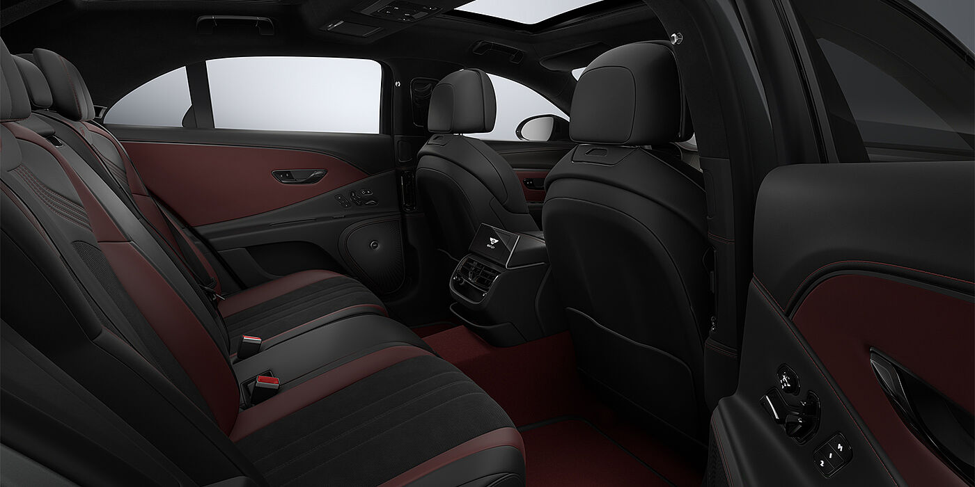 Bentley Düsseldorf New Bentley Flying Spur S sedan rear interior in Cricket Ball red  and Beluga black hides with High Gloss Carbon Fibre veneer
