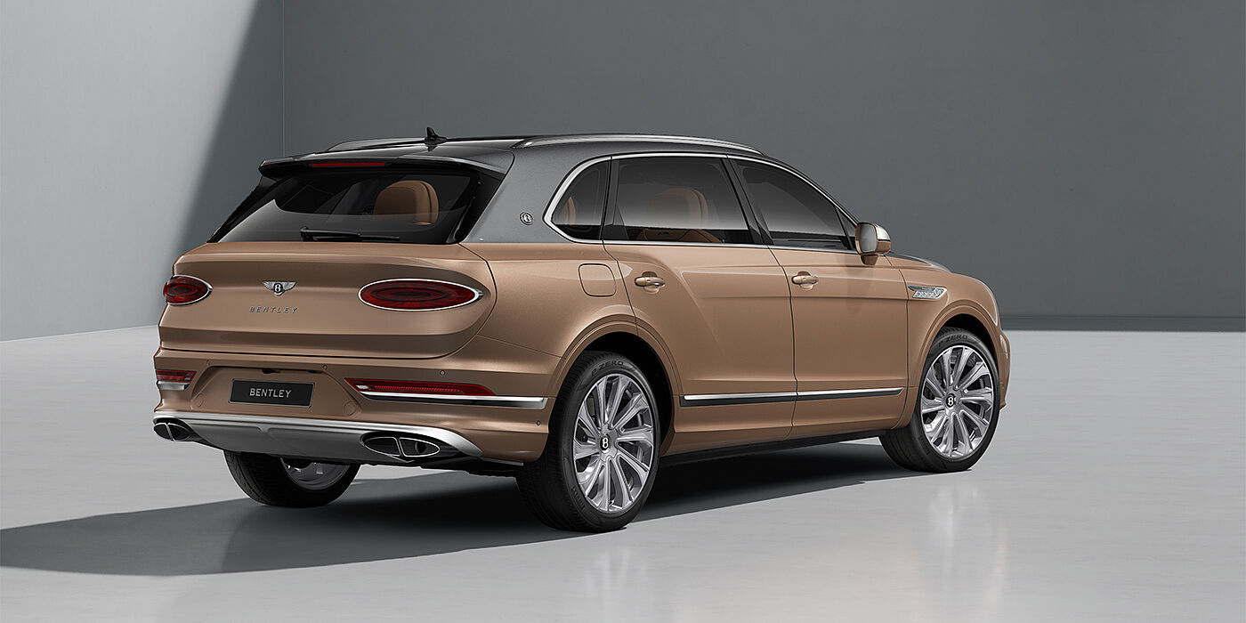 Bentley Düsseldorf Bentley Bentayga EWB Mulliner SUV in Magnetic and Rose Gold paint and 22" Mulliner wheels rear ¾