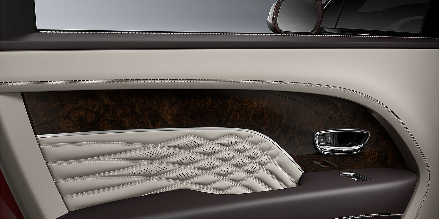 Bentley Düsseldorf Bentley Bentayga EWB Azure SUV door interior detail in Linen and Burnt Oak hides with Dark Stained Burr Walnut veneer