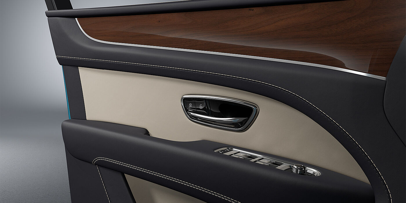 Bentley Düsseldorf Bentley Bentayga EWB SUV door interior detail in Portland and Imperial Blue hides with Crown Cut Walnut veneer