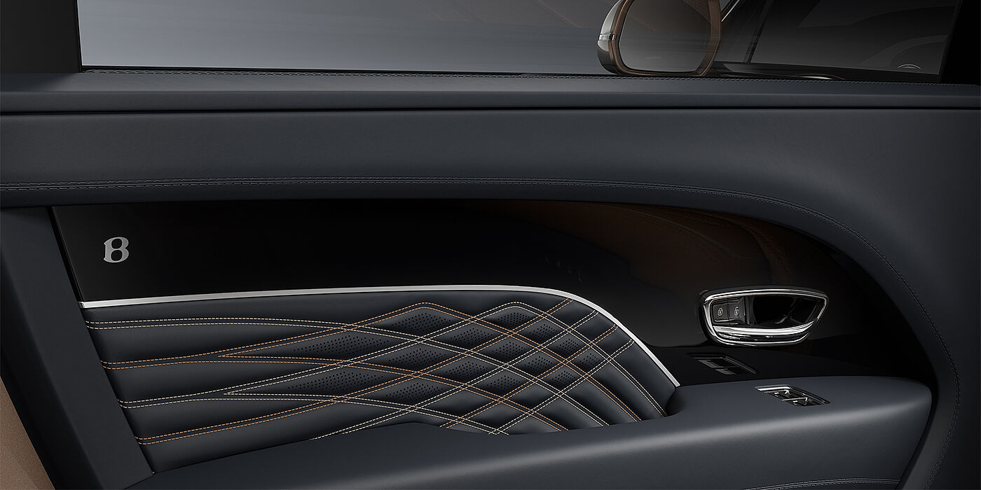Bentley Düsseldorf Bentley Bentayga EWB Mulliner SUV door interior detail in Brunel hide and Grand Black veneer with Mulliner contrast stitching