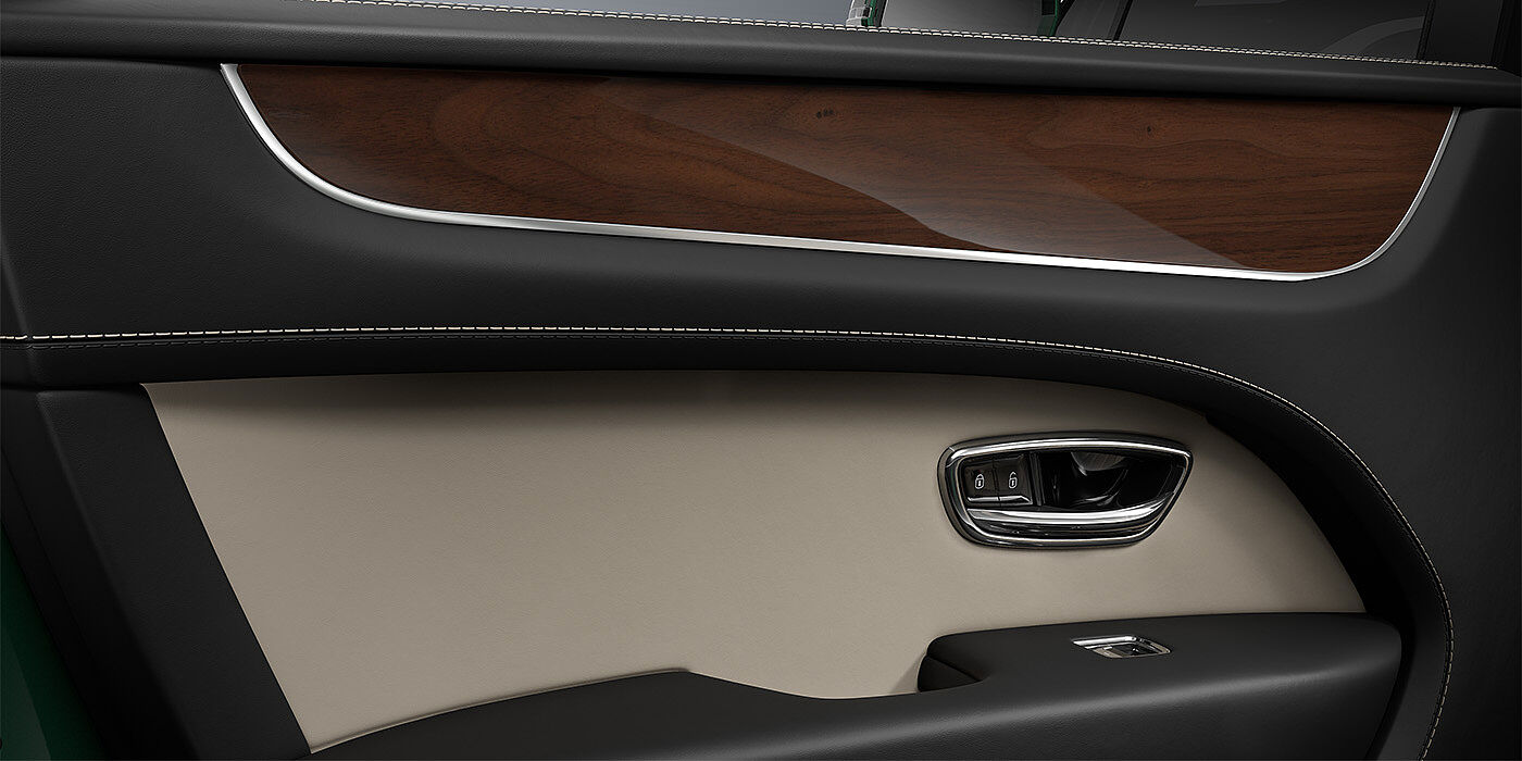Bentley Düsseldorf Bentley Bentayga SUV door interior detail in Portland and Beluga black hides with Crown Cut Walnut veneer