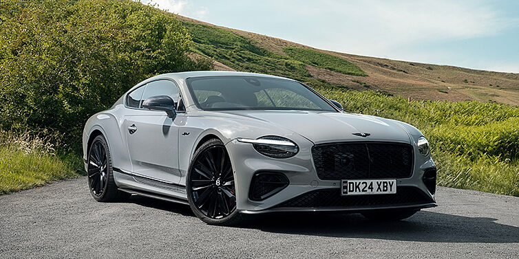 Bentley Düsseldorf Bentley Continental GT front three quarter with Carbon Fibre Specification parked on road.