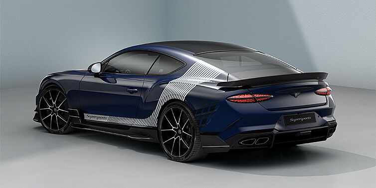 Bentley Düsseldorf Bentley Supersports rear three quarter in "Skies" Design theme with Electric Blue paint finish and Arctica white and Oxford blue paint stripes across the rear haunch.