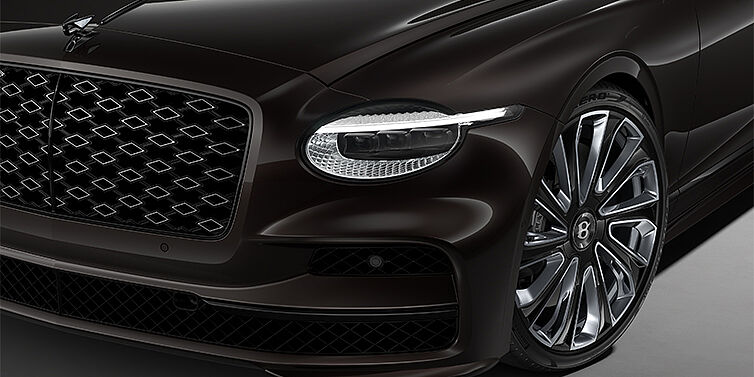 Bentley Düsseldorf New Bentley Flying Spur Mulliner sedan head lamp against Havana brown paint with 22" Mulliner Black Painted & Polished wheel