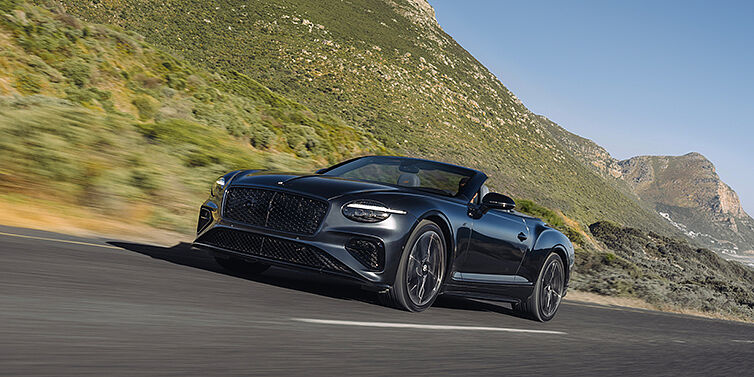 Bentley Düsseldorf Bentley Continental GTC S convertible in Thunder paint front 3/4 driving on mountain road