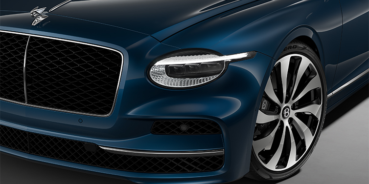 Bentley Düsseldorf New Bentley Flying Spur sedan head lamp against Marlin blue paint with 22" Ten Spoke Black Painted and Bright Machined wheel