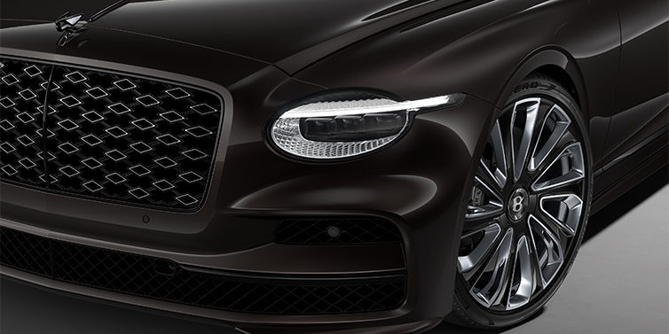 Bentley Düsseldorf New Bentley Flying Spur Mulliner sedan head lamp against Havana brown paint with 22" Mulliner Black Painted & Polished wheel