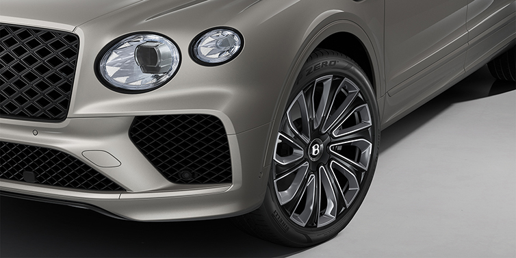 Bentley Düsseldorf Bentayga EWB Artenara Edition SUV in Pale Brodgar paint with 22" Mulliner Gloss black wheel close up