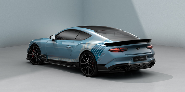 Bentley Düsseldorf Bentley Supersports rear three quarter in "Daybreak" Design theme with Jetstream blue paint and Arctica white and Portofino blue paint stripes across the rear haunch.